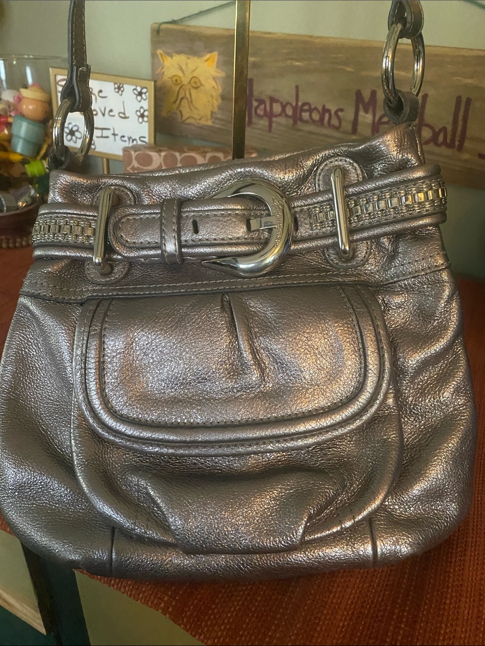 B. Makowsky metallic silver leather hobo with Buckle Accent and studded Belt.
